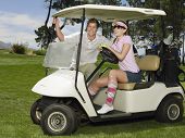 stock photo of golf  - Two young caucasian golfers in golf cart - JPG 