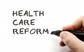 pic of health  - Health Care Reform written in black by a hand just finishing making a great health care or health insurance concept - JPG 
