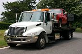 pic of truck  - White Flatbed truck towing an old red pickup truck - JPG 