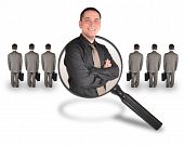 picture of competition  - A business man is smiling inside of a magnifying glass - JPG 