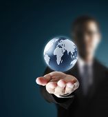 stock photo of globe  - holding a glowing earth globe in his hands - JPG 