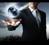 stock photo of globe  - holding a glowing earth globe in his hands - JPG 