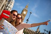 stock photo of holidays  - Couple of tourists in London holding a map - JPG 