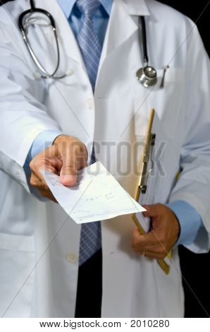 Picture or Photo of Focus on thumb of hand giving prescription all patient or doctor info has been removed from form except the scribbling indicating medication