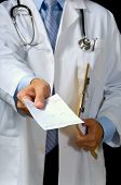 image of medical doctors  - focus on thumb of hand giving prescription all patient or doctor info has been removed from form except the scribbling indicating medication - JPG 