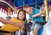 picture of laughter  - Kids having fun on a carnival Carousel - JPG 