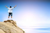 stock photo of nature  - Man with arms raised in the sky winner success concept - JPG 