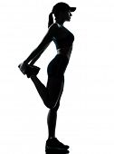 foto of woman  - one caucasian woman runner jogger stretching legs in silhouette studio isolated on white background - JPG 