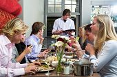 picture of restaurant  - Waiter taking orders from a group of dinner guests at a restaurant - JPG 