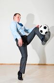 stock photo of business people  - caucasian business man is playing football at office near white wall - JPG 