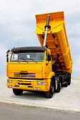 pic of discharge  - Big yellow construction tipper truck discharging loads - JPG 
