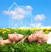 stock photo of dream  - Young love couple smiling dreaming about a new home - JPG 