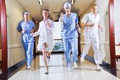 picture of medical doctors  - Doctor and nurse running in hallway of hospital - JPG 