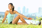 image of fitness  - Stretching woman in outdoor exercise smiling happy doing yoga stretches after running - JPG 