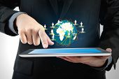 foto of device  - Business man using a touch screen device with social network  - JPG 