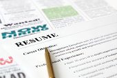 stock photo of newspaper  - Closeup of Resume with Pen on the Newspaper - JPG 