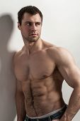 foto of health  - Handsome muscular guy with naked torso isolater over a grey background - JPG 