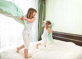 picture of wake  - Little girls fighting using pillows in bedroom - JPG 