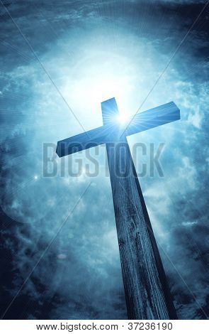 Picture or Photo of Wooden cross on dark sky, abstract background