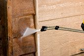 picture of pressure  - The side of a garage being pressure washed  - JPG 