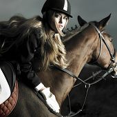 picture of horse  - Elegant woman in a black coat riding on a brown horse
 - JPG 