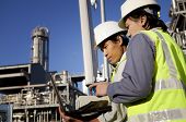 pic of industrial  - two engineer power and energy discussion on location site using laptop - JPG 