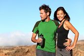 stock photo of fitness  - Young multicultural couple outdoors in sporty outfit - JPG 