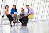 pic of meeting  - Businesspeople Having Meeting Around Table In Modern Office - JPG 