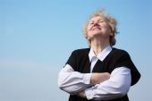 image of blue sky  - Elderly woman with crossed hands on sky - JPG 