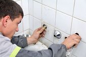 image of leak  - Plumber fixing pipeline with tool in handsand checking leaking - JPG 