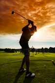 stock photo of golf  - Young golf player on course doing golf swing - JPG 