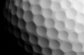stock photo of golf  - closeup of golf ball isolated on black - JPG 