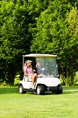 picture of golf  - Young sportive couple playing golf on a golf course - JPG 
