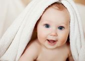 picture of wrapped  - A beautiful smiling baby wrapped in quilt - JPG 