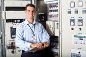 stock photo of industrial  - portrait of industrial engineer in front of computerized machinery - JPG 