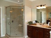 picture of marble  - Luxurious marble bathroom with glass enclosed shower and dark wood vanity - JPG 
