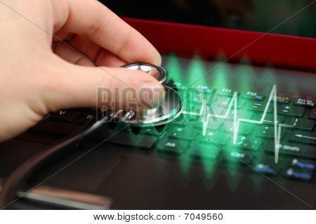 Picture or Photo of Male hand with stethoscope over black keyboard of laptop
