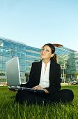picture of business people  - Business woman working on grass with laptop computer - JPG 
