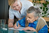stock photo of home  - Assisting a senior woman by nurse at home - JPG 