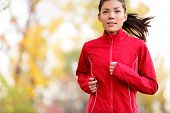 picture of fitness  - Woman runner running in autumn forest - JPG 