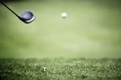 foto of golf  - Golf ball in the air after hit by driver while practicing at driving range - JPG 