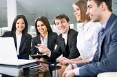 picture of meeting  - Group of happy multi ethnic business people in a meeting at office - JPG 