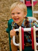 foto of teeter  - happy child ssmiling and playing on the teeter totter - JPG 