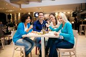 image of restaurant  - Group of young people having lunch in restaurant - JPG 