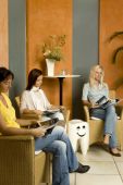 stock photo of wait  - a group of patients waiting in the waiting room of a dentist practice - JPG 