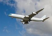 stock photo of blue sky  - An Aircraft with its landing gear down against a blue sky - JPG 