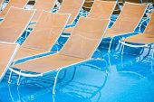 stock photo of pulldown  - textile chairs on wet deck of cruise liner in rainy day - JPG 