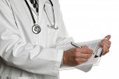 pic of medical doctors  - Male doctor filling out a medical document or patient examination notes - JPG 