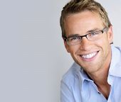 picture of lifestyles  - Young handsome man with great smile wearing fashion eyeglasses against neutral background with lots of copy space - JPG 