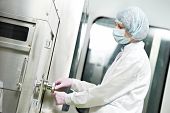 stock photo of industrial  - pharmaceutical factory woman worker operating production line at pharmacy industry manufacture factory - JPG 